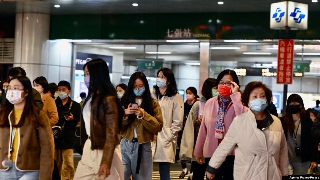 Commuters exit a Mass Rapid Transport (MRT) station in Xindian in New Taipei City on Jan. 3, 2022, after a strong earthquake struck off the coast of eastern Taiwan with shaking felt in the capital Taipei.