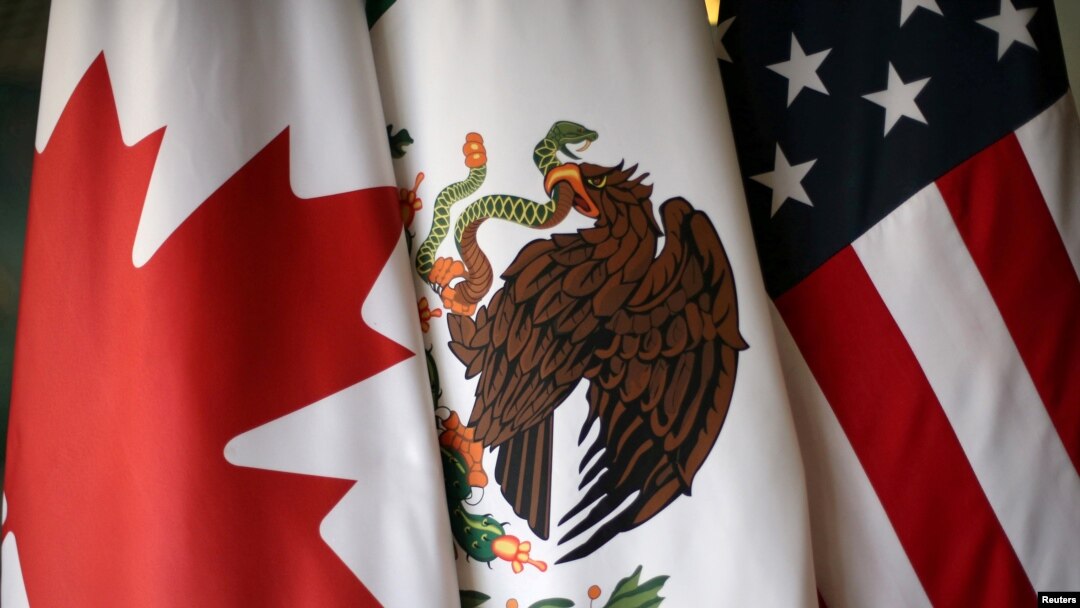 FILE - Flags are pictured during the fifth round of NAFTA talks involving the United States, Mexico and Canada, in Mexico City, Mexico, November 19, 2017.