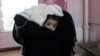 A woman carries a child at the malnutrition ward of al-Sabeen hospital in Sanaa, Yemen, Sept.11, 2018. 