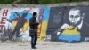 A man looks at a graffiti produced to support the territorial integrity of Ukraine and to protest Russia's annexation of the Black Sea peninsula of Crimea in Odessa, April 7, 2014.