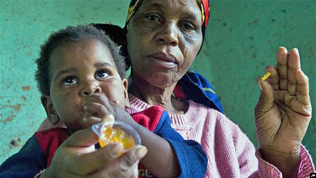 HIV positive child, Gift, no second name provided, is given some jam prior to her ARV medication by a caregiver near Durban South Africa, November 2010 (file photo)