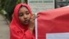 FILE - A campaigner from "#Bring Back Our Girls" hold a banner during a rally calling for the release of the Chibok school girls who were abducted by the Boko Haram militants, outside the Cameroon Embassy in Abuja, October 17, 2014.