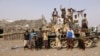 Tribal fighters loyal to the Yemeni government stand by a tank in al-Faza area near Hodeida, Yemen June 1, 2018. 