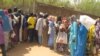FILE- Cameroonian internally displaced queue at a camp in Kolofata, in the extreme north of Cameroon, for a food distribution provided by the International Red Cross Committee (ICR) on Feb. 22, 2017.