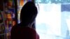 FILE - Nigerian ex-prostitute "Beauty" (a pseudonym), poses in a social support centre for trafficked girls near Catania in Italy, Sept. 14, 2016. 