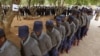 Zimbabwean police officers wait in line to cast their votes at a polling station in Harare, July 15, 2013. Early voting started for police and security personnel who will be on duty during the nation's July 31elections. 