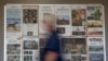 FILE - Some front pages and section fronts of the Orange County Register are seen in the newsroom in Santa Ana, Calif., Dec. 27, 2012. 