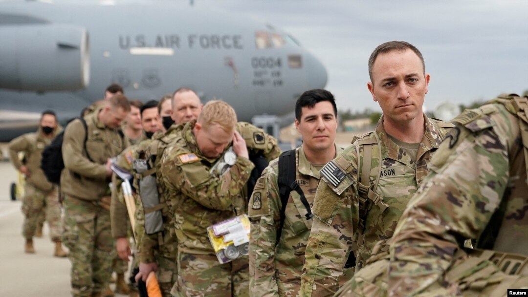 Military personnel from the 82nd Airborne Division and 18th Airborne Corps board a C-17 transport plane for deployment to Eastern Europe, amid escalating tensions between Ukraine and Russia, at Fort Bragg, North Carolina, Feb. 3, 2022. 