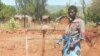 Woman at water tap