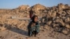 FILE- An Afghan girl cries in front of her house that was destroyed by the earthquake in western Afghanistan, on Oct. 11, 2023. Almost 100,000 children need support three months after earthquakes devastated the Herat region, the U.N. children’s agency said Jan. 15, 2024.