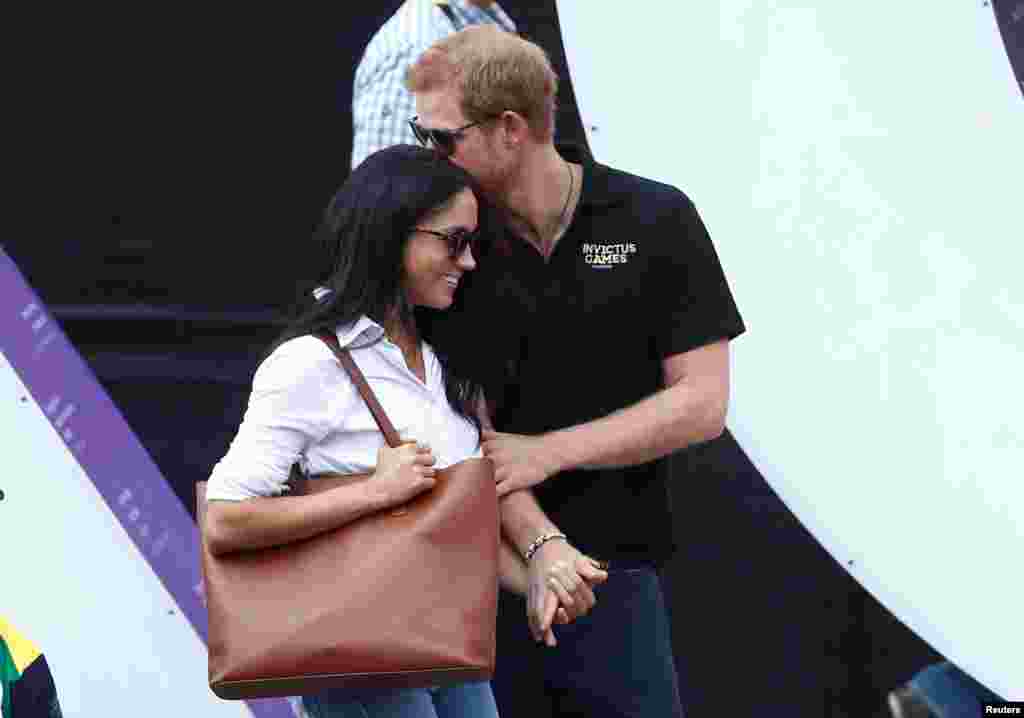 Britain's Prince Harry (R) arrives with girlfriend Meghan Markle at the wheelchair tennis event during the Invictus Games in Toronto, Ontario, Canada, Sept. 25, 2017.