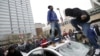 Protesters jump on a police car at a rally to protest the death of Freddie Gray who died following an arrest in Baltimore, April 25, 2015. 