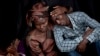 Bizimana Emmanuel, who was born two years before the genocide, is consoled by an unidentified woman while attending a ceremony to mark the 20th anniversary of the Rwandan genocide, at Amahoro stadium in Kigali, Rwanda, April 7, 2014. 