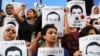 FILE - Protesters rally in support of three detained Al Jazeera journalists in front of the Press Syndicate in Cairo, Egypt, June 1, 2014.