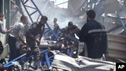 FILE - An image made from video posted online by the Shaam News Network, a loosely organized group opposed to Bashar Assad, shows rescuers taking a victim from the site of Syrian government airstrikes in Douma, a suburb of Damascus, Aug. 16, 2015. 