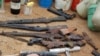 FILE - Confiscated weapons are displayed after a military raid on a hideout of suspected Islamist Boko Haram members in Nigeria's northern city of Kano, Aug. 11, 2012.