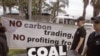 People walk with a coffin as they protest against the usage of coal during a climate change conference at the city of Durban, South Africa, December 1, 2011.
