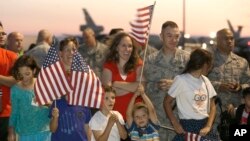FILE - U.S. Air Force personnel and their families wait for the arrival of Airman 1st Class Spencer Stone, one of three Americans who tackled a heavily armed gunman on a Paris-bound train, at Travis Air Force Base in Fairfield, California, Sept. 3, 2015.