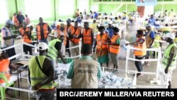 FILE - Officials stand around ballots in Buka, Bougainville, Papua New Guinea, Dec. 9, 2019. (Bougainville Referendum Commission/Jeremy Miller/Handout via Reuters) 