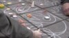 People scrawl messages on the sidewalk at the Place de la Bourse in downtown Brussels in response to the terrorist attacks that left dozens of people dead, March 23, 2016. (L. Bryant/VOA)