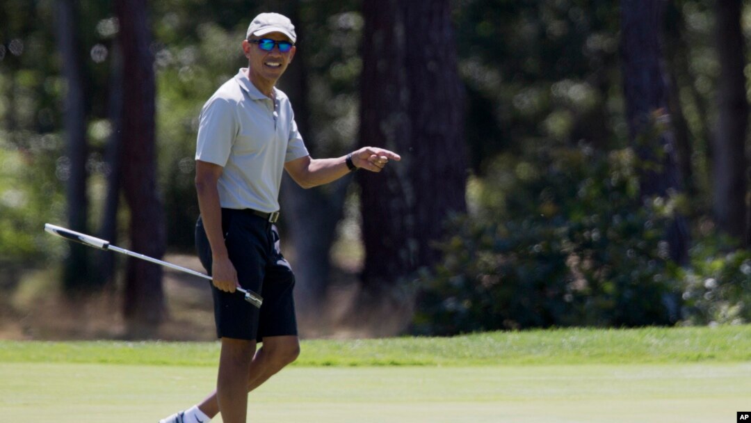 President Barack Obama reacts after putting on the first green as he plays golf at Farm Neck Golf Course in Oak Bluffs, Mass., on Martha's Vineyard, Aug. 7, 2016.