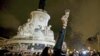 A man holds a glass of champaign on the "Republique" square, a week after a series of deadly attacks in the French capital, in Paris, France, Nov. 20, 2015.