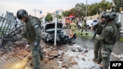 Israeli policemen and rescue personnel search the site of a rocket attack from Gaza in Beitar Illit, a town in the Gush Etzion settlement cluster in the occupied West Bank, on October 9, 2023.