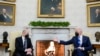 President Joe Biden, right, gestures during a meeting with German Chancellor Olaf Scholz in the Oval Office of the White House, in Washington, Feb. 7, 2022.