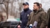 FILE - In this handout photo provided by the Ukrainian Presidential Press Office, Ukrainian President Volodymyr Zelenskyy, right, speaks at a press conference in Kherson, Ukraine, Feb. 12, 2022. 