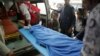 FILE - Yemenis carry the body of a girl who was killed in an explosion at a warehouse in Sanaa, April 7, 2019.