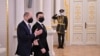 This handout picture taken and released by the Ukrainian presidential press-service shows President Volodymyr Zelensky welcoming German Chancellor Olaf Scholz ahead of their meeting in Kyiv on Feb. 14, 2022.