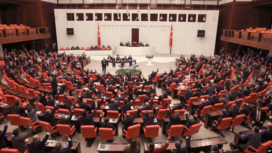 Members of Turkey's parliament vote to send Turkish troops to Libya to help the U.N.-supported government in Tripoli battle forces loyal to a rival administration in eastern Libya that is seeking to capture the capital, in Ankara, Turkey, Jan. 2, 2020.
