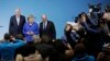 German Chancellor Angela Merkel is flanked by Bavarian governor Horst Seehofer (L) and Social Democratic Party Chairman Martin Schulz as they pose for a photo after the exploratory talks between Merkel's Christian Democratic block and the Social Democrats on forming a new German government in Berlin, Germany, Jan. 12, 2018. 