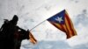 An Estelada (Catalan separatist flag) waves overhead during a protest one day after the banned independence referendum in Barcelona, Spain, Oct. 2, 2017. 