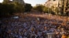 Spain Catalonia Independence: People wave "estelada" flags, that symbolize Catalonia's independence, during a demonstration calling for the independence of Catalonia, in Barcelona, Spain, Sunday, Sept. 11, 2016. 