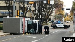 FILE - Edmonton Police investigate at the scene where a man hit pedestrians then flipped the U-Haul truck he was driving, in Edmonton, Alberta, Canada, Oct. 1, 2017.