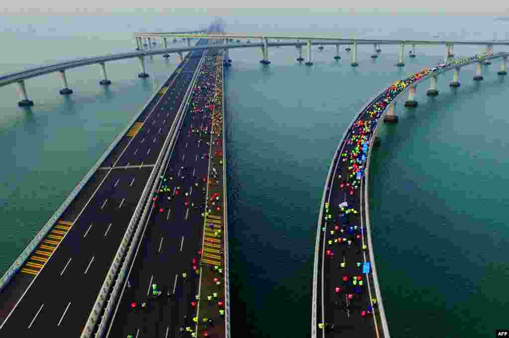 This photo shows participants crossing the Jiaozhou Bay Bridge as they compete in the 2017 Qingdao International Marathon on the Sea in Qingdao in China's eastern Shandong province. 