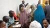 Detained Somali women are fingerprinted and screened at the Kasarani sports stadium, which has been converted into a detention facility to hold those arrested during recent security crackdowns, near Nairobi, April 9, 2014.