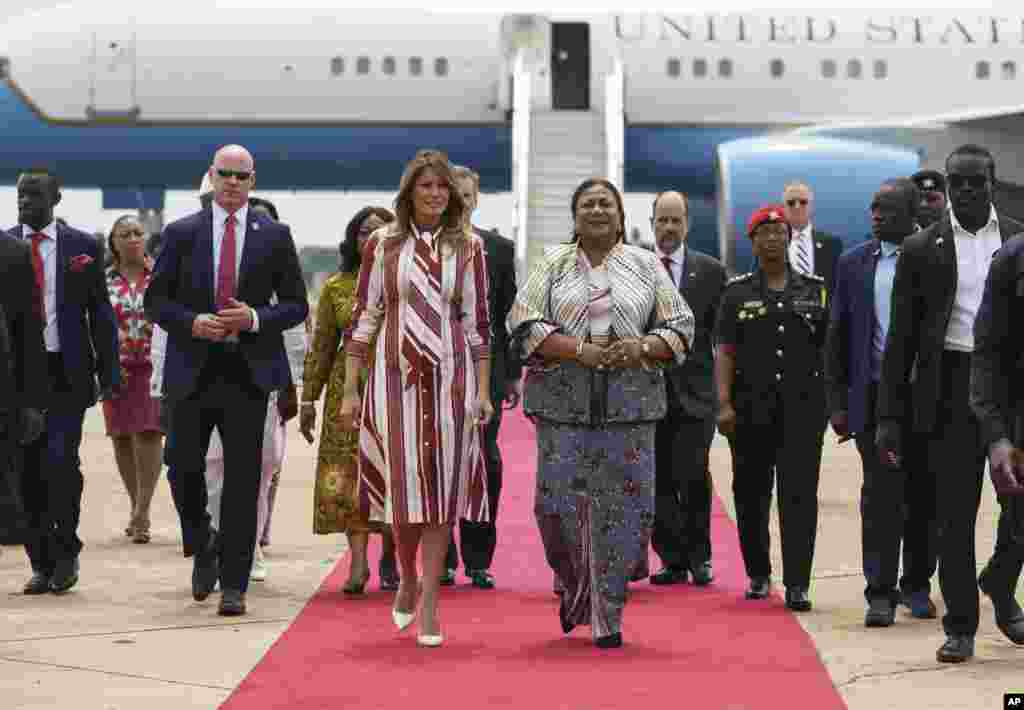 First lady Melania Trump walks with Ghana's first lady Rebecca Akufo-Addo as she arrives at Kotoka International Airport in Accra, Ghana, Oct. 2, 2018.