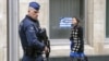 FILE - A Belgian police officer secures the area around the European Council headquarters.