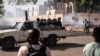 Security forces drive towards protestors to fire tear gas during a demonstration in Ouagadougou on Nov. 27, 2021.