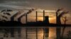 FILE - The coal-fired Plant Scherer, one of the top carbon dioxide emitters in the U.S., stands in the distance in Juliette, Georgia, June, 3, 2017.
