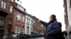 A resident points at a house located in a street called "Rue du Fort" in Charleroi, Belgium, Jan. 13, 2016. 