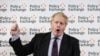 Britain's Foreign Secretary Boris Johnson wipes his forehead as he delivers a speech at the Policy Exchange in London, Wednesday Feb. 14, 2018.