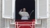 Pope Francis waves to faithful during the Angelus noon prayer in St. Peter's Square at the Vatican, June 3, 2018.