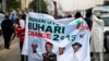 All Progressives Congress (APC) supporters hold a banner with a photograph of former military ruler Muhammadu Buhari in Lagos, Nigeria, Dec. 10, 2014.