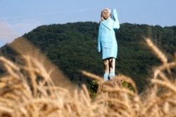 FILE - Life-size wooden sculpture of U.S. first lady Melania Trump is officially unveiled in Rozno, near her hometown of Sevnica, Slovenia, July 5, 2019.