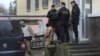 A crew member (C) of one of three Ukrainian naval ships, which were attacked and seized by Russia Sunday, is escorted after a court hearing in Simferopol, in Russia-annexed Crimea, Nov. 27, 2018.