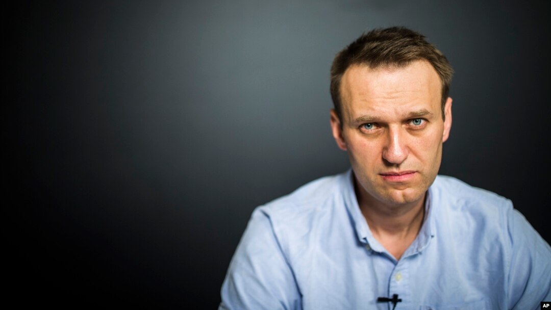 In this photo provided by Alexei Navalny's campaign, Russian opposition leader Alexei Navalny records a video for his YouTube channel in his office in Moscow, Russia, July 7, 2017.