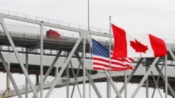 A truck crosses the Blue Water Bridge into Port Huron, Mich., from Sarnia, Ontario, Canada, March 18, 2020.